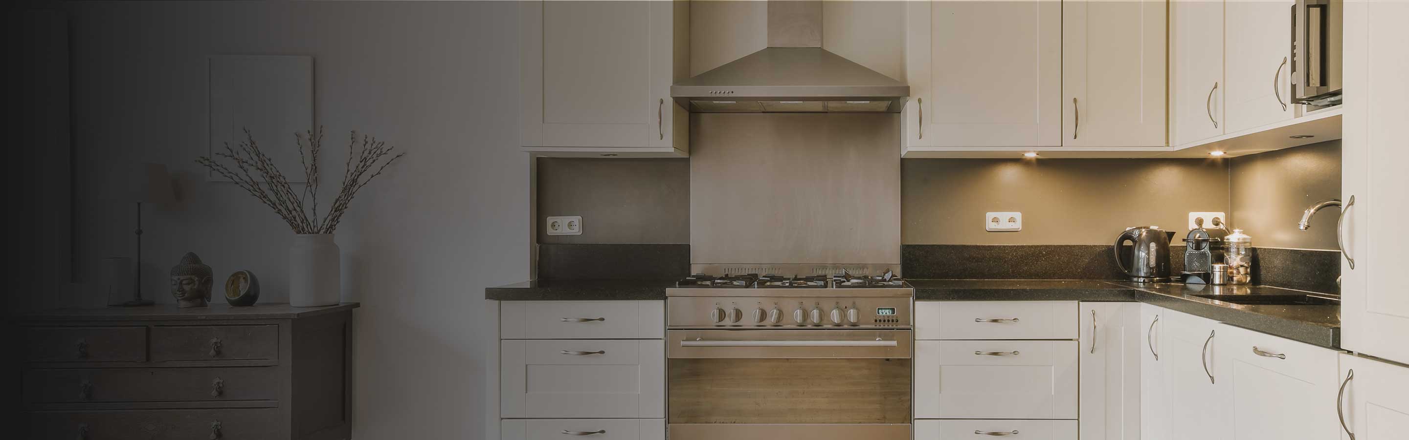 white cabinets and stone countertops with undercabinet lighting